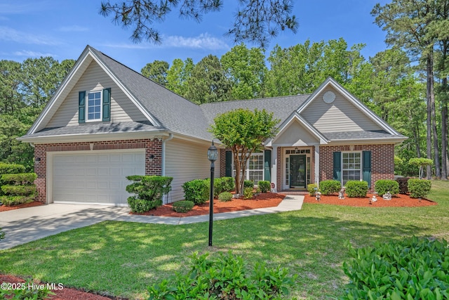 view of front of house with roof with shingles, concrete driveway, a front yard, and brick siding