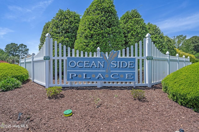 community sign featuring fence