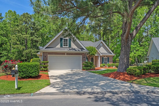 view of front of property featuring a garage, concrete driveway, and brick siding