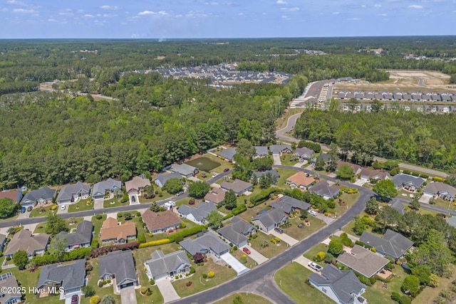 birds eye view of property featuring a wooded view and a residential view