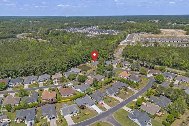 aerial view featuring a wooded view and a residential view