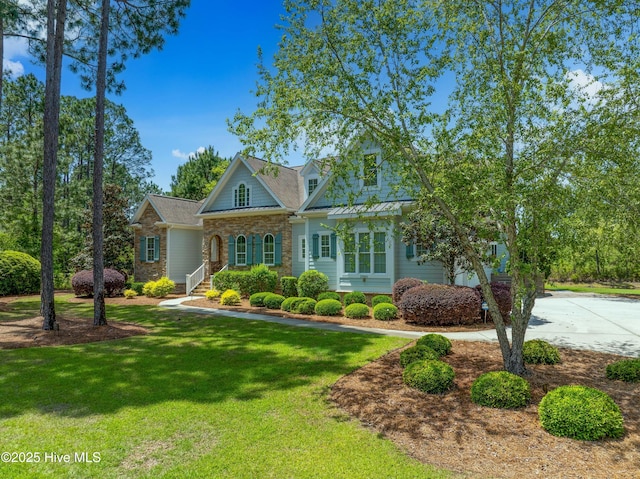 view of front of house with a front lawn and stone siding