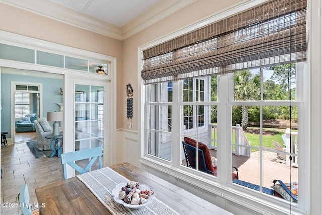 entryway with ornamental molding and stone tile floors