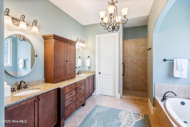 bathroom featuring a garden tub, double vanity, a chandelier, and a tile shower