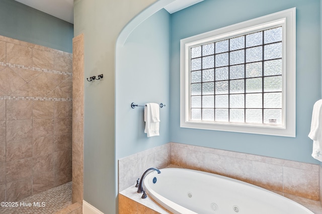 full bath featuring a whirlpool tub and tiled shower