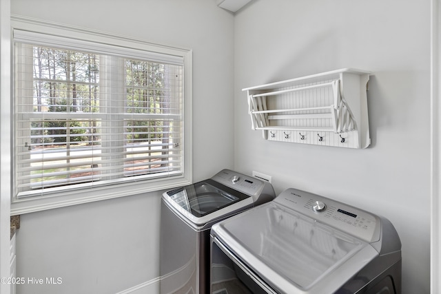 laundry room featuring separate washer and dryer and healthy amount of natural light