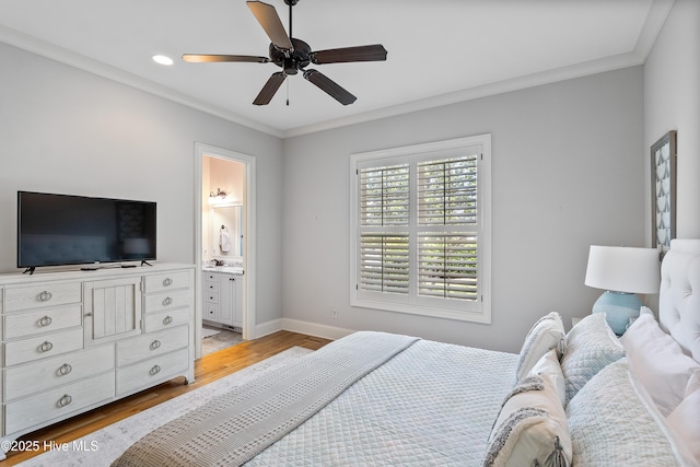 bedroom featuring light wood-style flooring, baseboards, crown molding, recessed lighting, and ensuite bathroom
