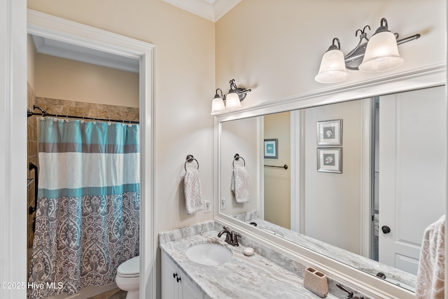 full bath with toilet, vanity, and ornamental molding