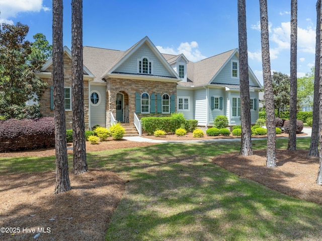 view of front of property featuring a front lawn and stone siding