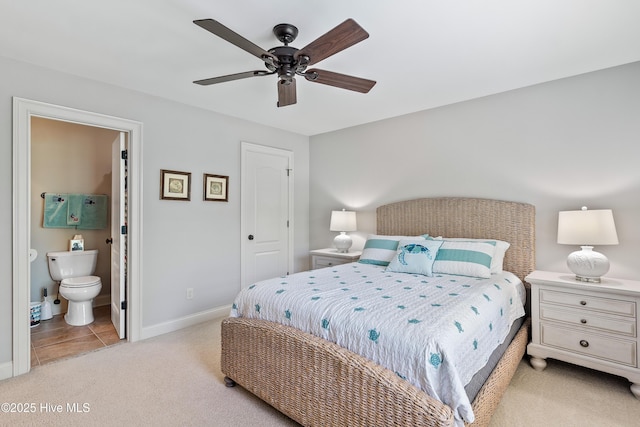bedroom featuring carpet floors, baseboards, connected bathroom, and a ceiling fan
