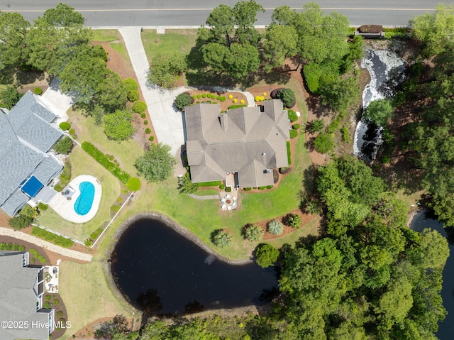 view of property location with a pool and a nearby body of water