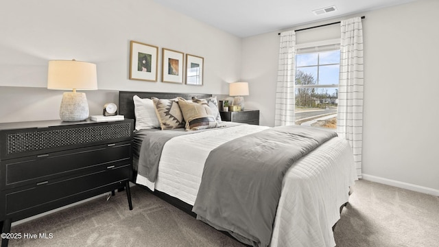 bedroom featuring baseboards, carpet flooring, and visible vents