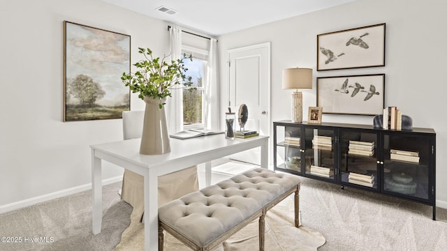 carpeted office space with baseboards and visible vents