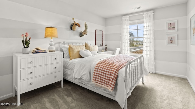 carpeted bedroom featuring baseboards and visible vents