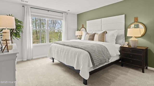 carpeted bedroom featuring baseboards and visible vents