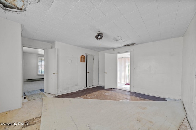 empty room featuring a baseboard radiator