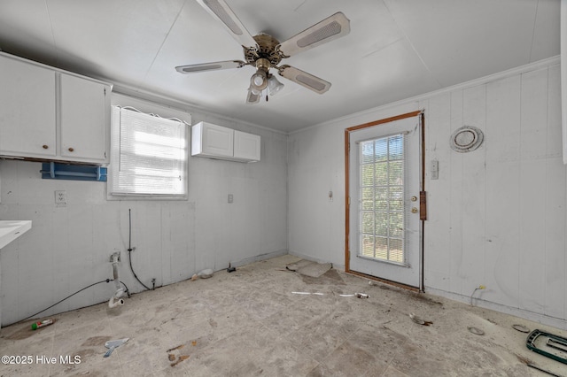 interior space with white cabinetry and ceiling fan