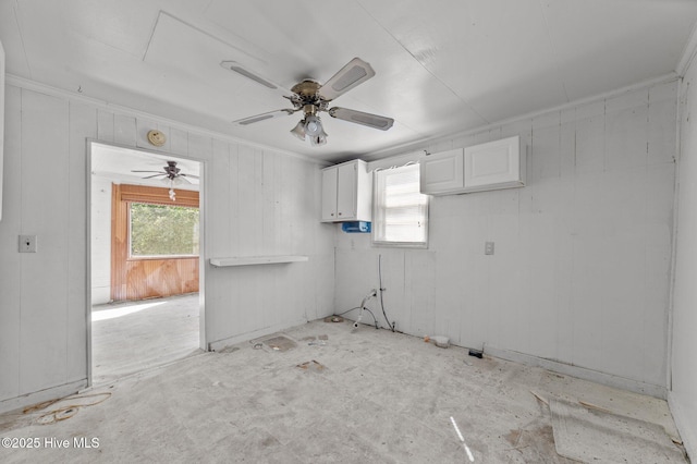 unfurnished room with ceiling fan and a healthy amount of sunlight