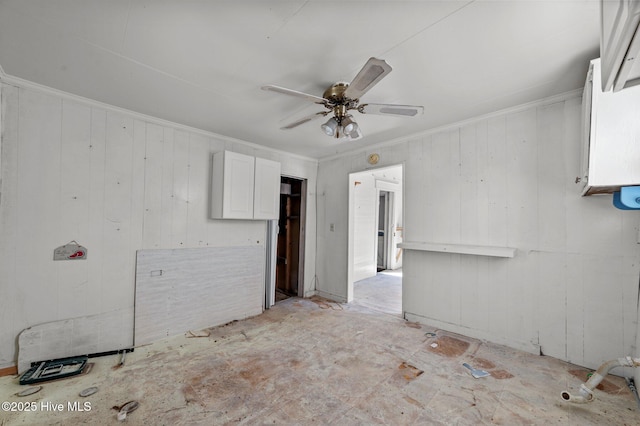 spare room featuring ornamental molding and a ceiling fan