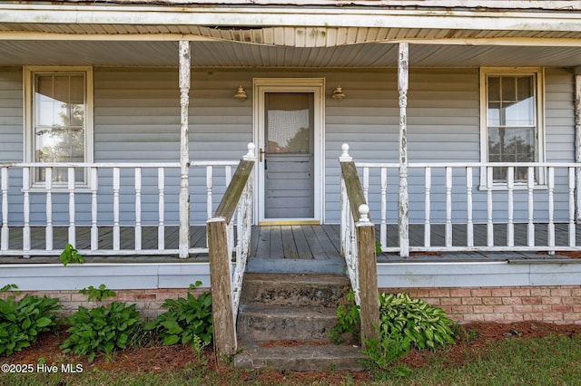 view of exterior entry with a porch