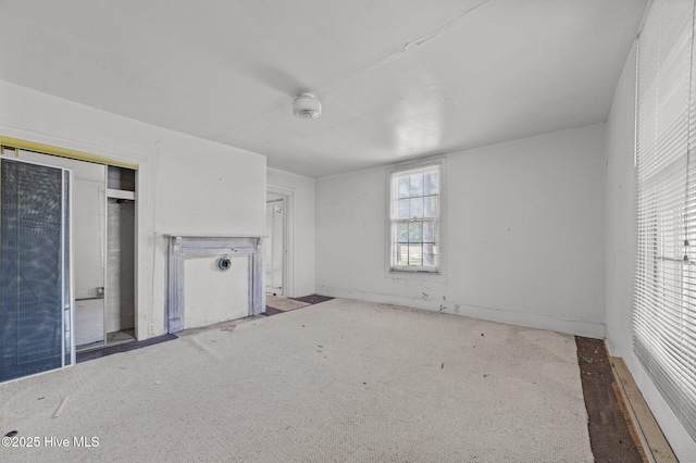 unfurnished living room with ceiling fan