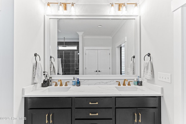 full bath with double vanity, ornamental molding, and a sink