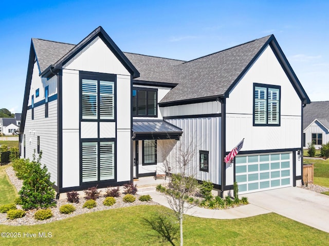 modern farmhouse featuring roof with shingles, an attached garage, a standing seam roof, and a front lawn