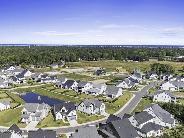 drone / aerial view with a water view and a residential view