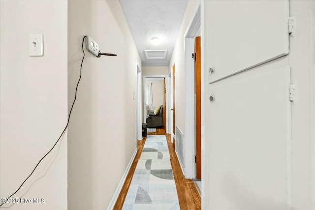 1109 Laurel Ave, Rockingham, NC 28379 - hallway featuring attic access and light wood-style floors