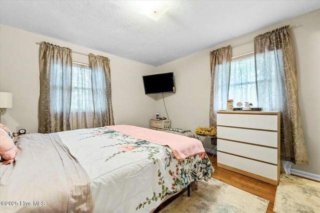 1109 Laurel Ave, Rockingham, NC 28379 - bedroom featuring wood finished floors and a textured ceiling