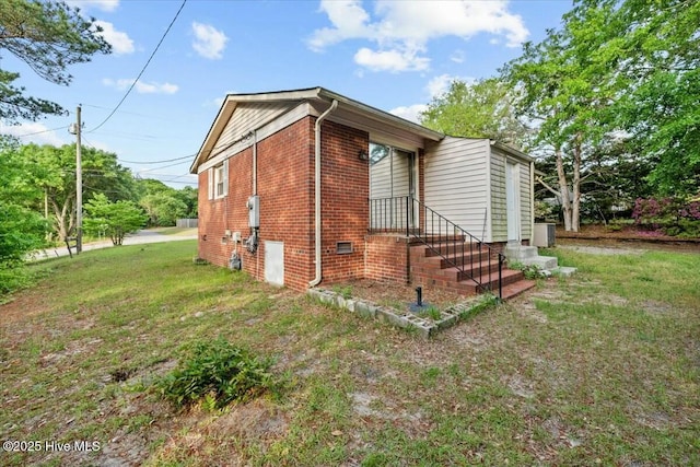 1109 Laurel Ave, Rockingham, NC 28379 - view of property exterior featuring a yard and brick siding