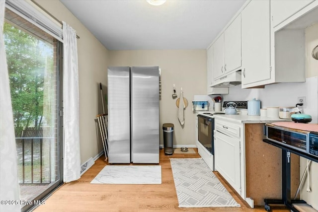 1109 Laurel Ave, Rockingham, NC 28379 - kitchen with freestanding refrigerator, electric range, healthy amount of natural light, and light countertops