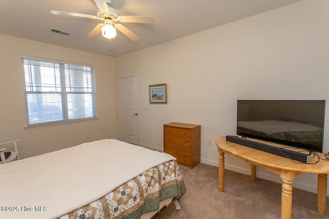 bedroom featuring light colored carpet, ceiling fan, and baseboards