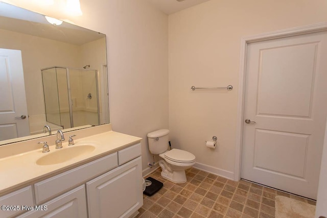 full bath with a shower stall, baseboards, toilet, and vanity