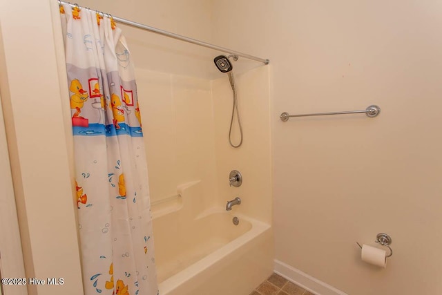 bathroom with shower / bath combination with curtain and baseboards