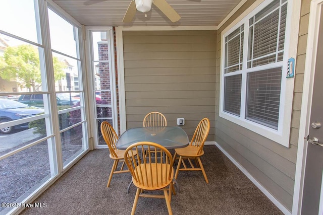 sunroom featuring ceiling fan, healthy amount of natural light, and outdoor dining space