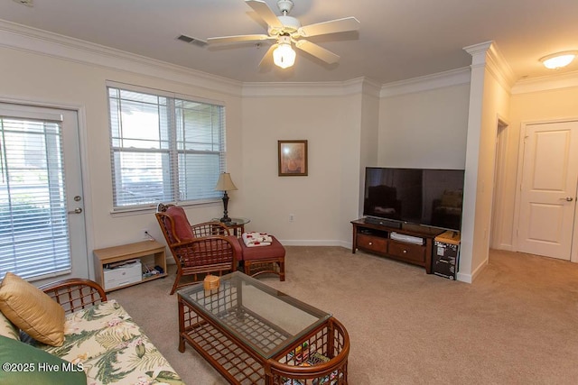 living room with ornamental molding, light carpet, a ceiling fan, and baseboards