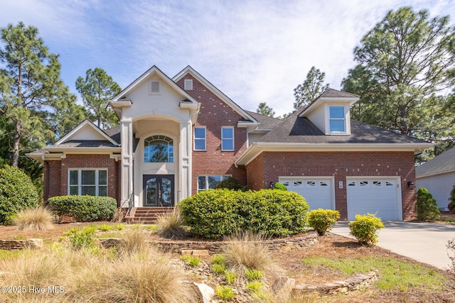 84 Deerwood Ln, Pinehurst, NC 28374 - traditional home featuring concrete driveway, brick siding, french doors, and a garage