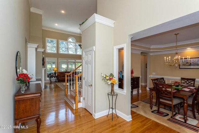 84 Deerwood Ln, Pinehurst, NC 28374 - entrance foyer with crown molding, wood finished floors, a notable chandelier, a high ceiling, and recessed lighting