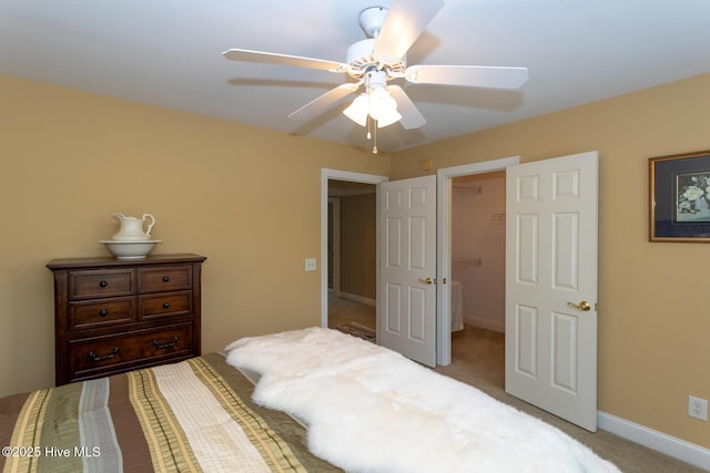 84 Deerwood Ln, Pinehurst, NC 28374 - bedroom featuring a ceiling fan, baseboards, a closet, a spacious closet, and carpet