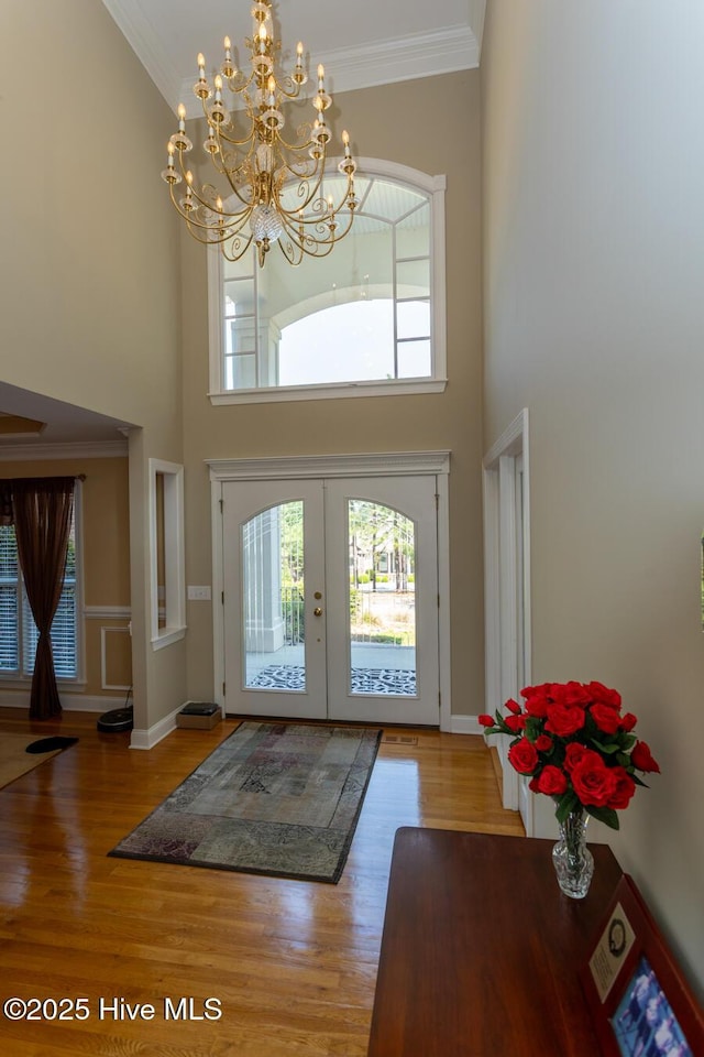 84 Deerwood Ln, Pinehurst, NC 28374 - entryway featuring crown molding, wood finished floors, and a towering ceiling