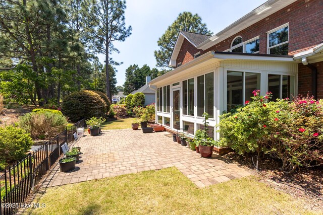 84 Deerwood Ln, Pinehurst, NC 28374 - view of patio / terrace with fence and a sunroom