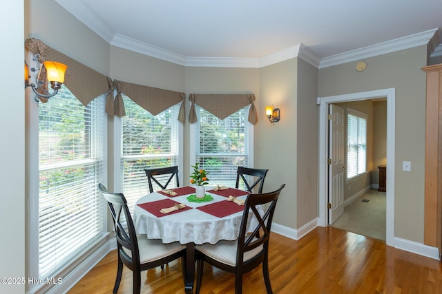 84 Deerwood Ln, Pinehurst, NC 28374 - dining room featuring light wood-style floors, baseboards, and crown molding