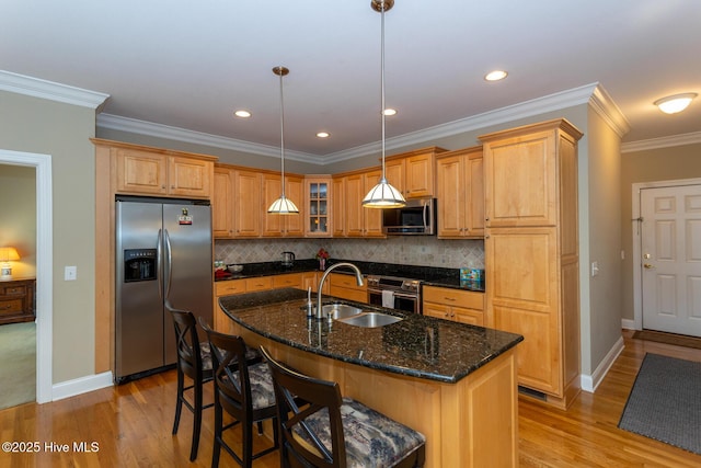 84 Deerwood Ln, Pinehurst, NC 28374 - kitchen with a sink, baseboards, stainless steel appliances, and light wood-style flooring