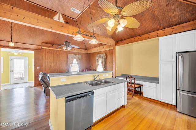 kitchen with a sink, lofted ceiling, wooden ceiling, and stainless steel appliances