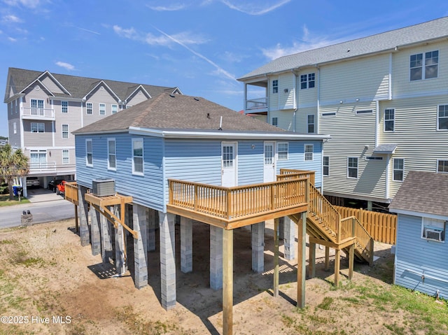 back of house with a shingled roof, a residential view, a wooden deck, and stairway