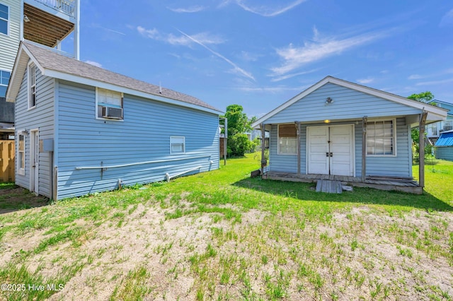 rear view of house featuring a lawn