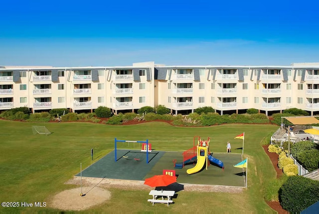 view of home's community with a yard and playground community