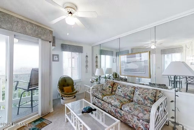 living area featuring crown molding and a ceiling fan