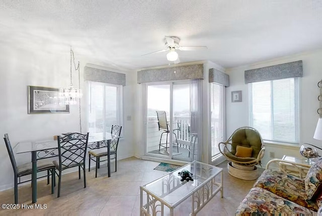 living room with ceiling fan and a textured ceiling